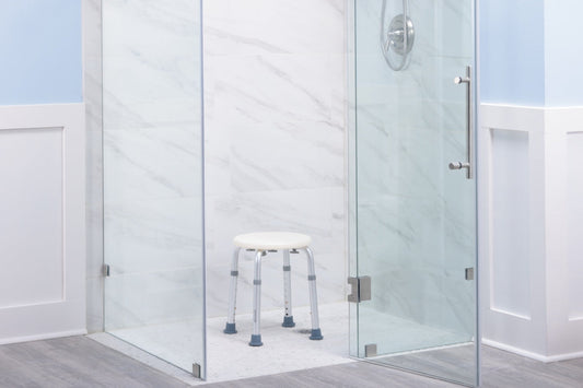 Handicap accessible bathroom with grab bars and shower seat installed for safe bathing